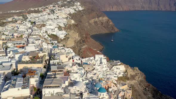 Aerial shot of famous Oia village in Santorini at sunrise in Greece.