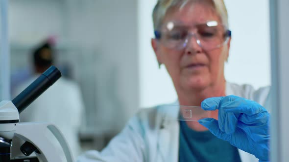 Close Up of Lab Engineer Analysing Virus Sample