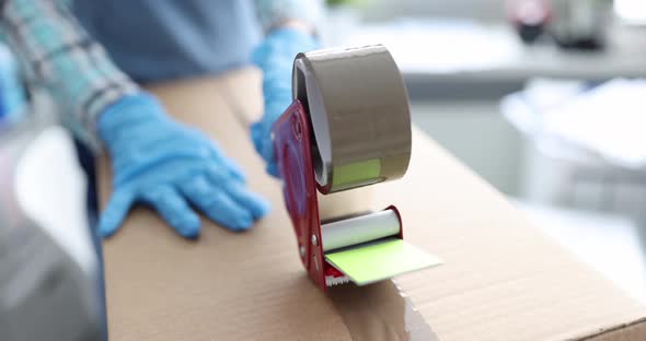 Courier Works with Cardboard Boxes Packing with Tape