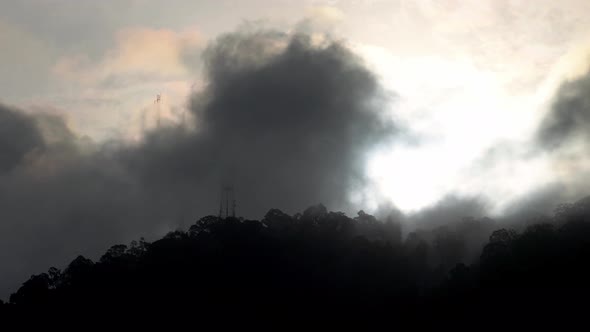 Timelapse misty fog morning over communication tower on hill