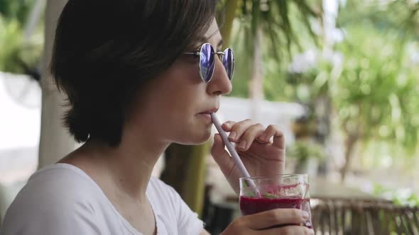 Girl Drinks a Cocktail in a Cafe on the Street. Healthy Eating Freshly Squeezed Juice or Smoothie