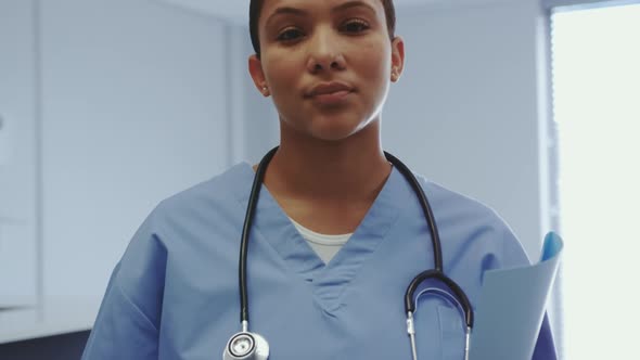 Female doctor standing with medical file in hospital 4k