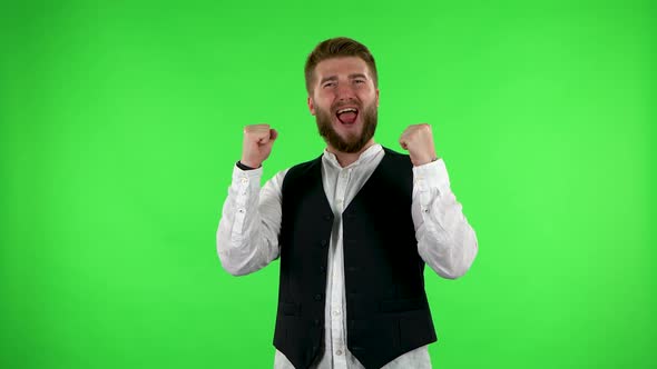 Male Looking at the Camera, Then Celebrating His Victory Triumph on Green Screen.