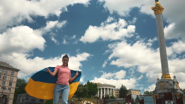 Young Woman with National Flag of Ukraine on the Street