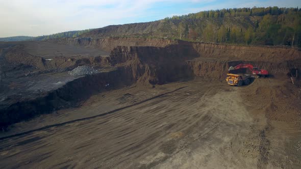 Aerial Hyperlapse Excavator Loads Dump Truck with Earth