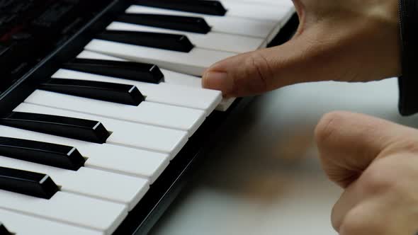 Playing the Synthesizerfingers on Piano Keys