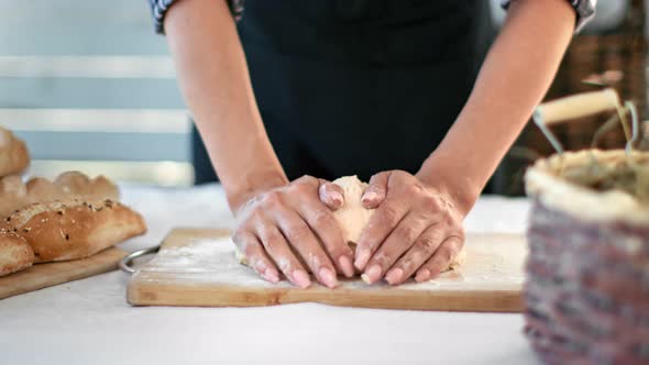 Closeup Hands of Female Bakery Chef Knead Dough on Table