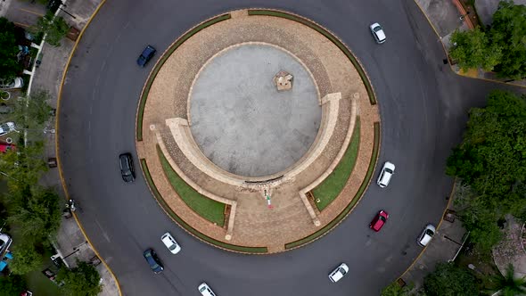 Aerial ascent looking straight down on the Monument a la Patria, Homeland Monument and traffic circl