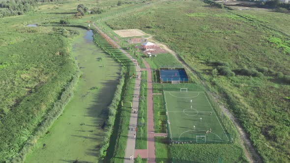 Modern city quay with sports courts, athletic fields and children playground