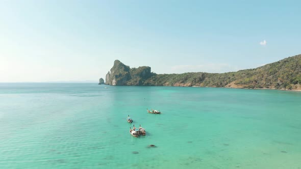 Breathtakingly beautiful Loh Dalum Bay, with Long-tail boats moored above Turquoise clear sea