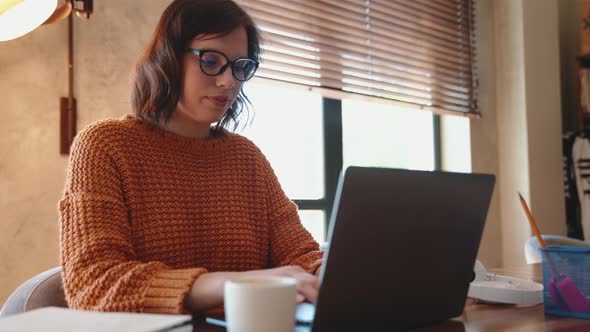 Positive red haired woman working