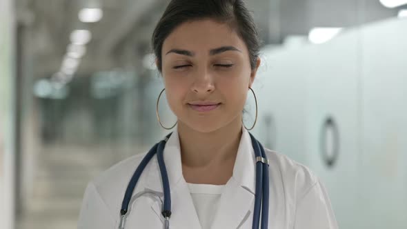 Portrait of Serious Indian Female Doctor Looking at Camera