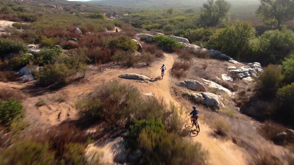 4K Drone San Diego Close Up Mountain Bikers Going Uphill In Competition