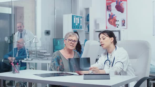 Doctor Using X-rays To Consult with Patient