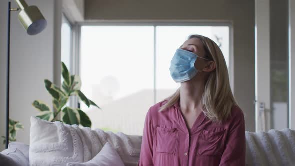 Woman wearing face mask at home