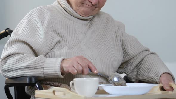 Senior Disabled Lady Refusing to Eat Dinner in Hospital, Nurse Taking Food Away