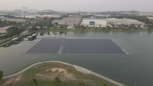 Floating solar panels on lake, alternative power generator, Aerial upwards and tilt down