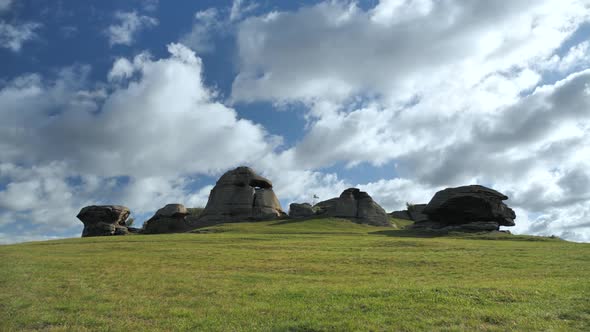 Natural Landscape of Huge Stones on a Green Flat Meadow