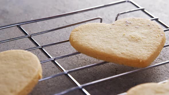 Raw heart shape cookies with sugar icing on baking tray 4k