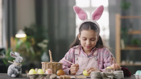 Portrait of Girl Decorating Easter Eggs