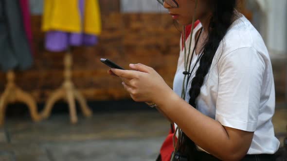 Young Asian woman hand using a smartphone.