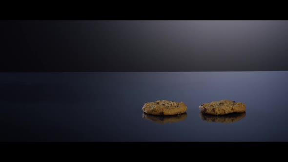 Falling cookies from above onto a reflective surface - COOKIES 
