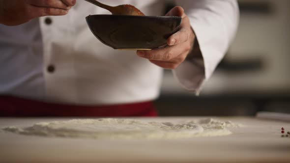 Chef Cooking Italian Pizza on Wooden Board