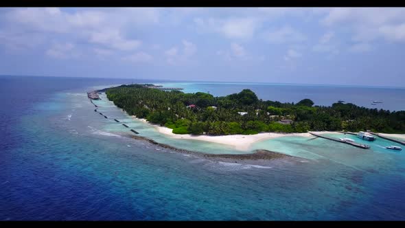 Aerial top down scenery of relaxing resort beach holiday by blue lagoon with white sandy background 