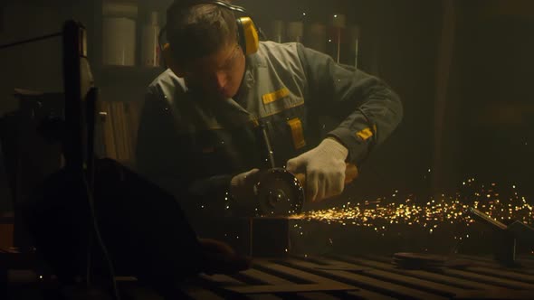 Industrial worker cutting metal