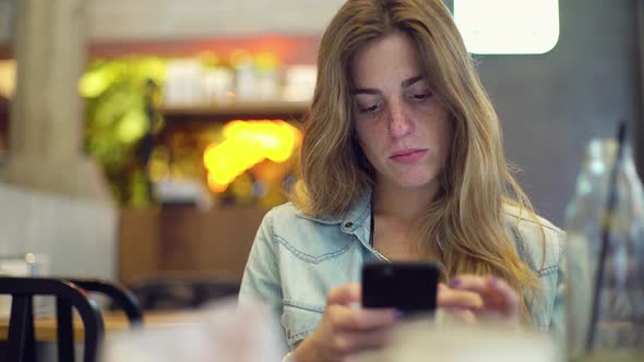 Young woman sending instant messages on smartphone