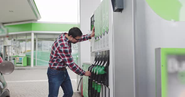 Man Takes A Fuel Pistol To Refuel The Car