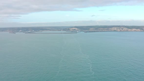Wide aerial shot from the sea of ferry leaving Dover harbour