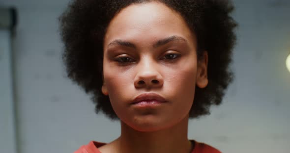 Young African American Woman Turns Her Head and Serious Looks Into the Camera