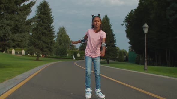 Lovely Joyful African Girl Rollerblading in Park