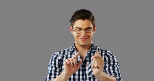 Smiling man using futuristic digital tablet