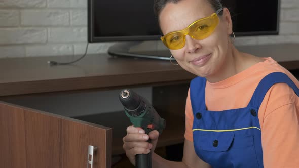 Woman drill a door