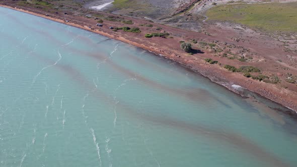 A Beach with Blue Water Color and Sandy Waves