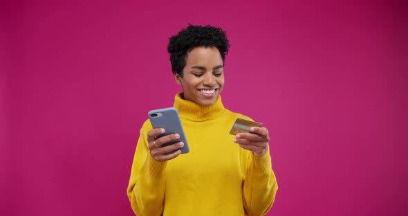 Portrait Smiling Afro American Woman Makes Online Purchase Through Mobile Phone