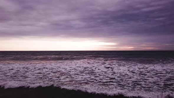 Beautiful bright sunset over the waves of the Ecuador from Olon Beach -wide