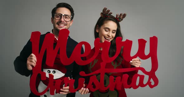 Funny couple wishing Merry Christmas to all