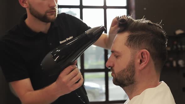 Hairdresser Making Hairstyle in Male Salon