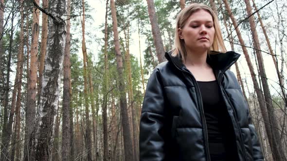 Woman enjoying countryside walking in woods