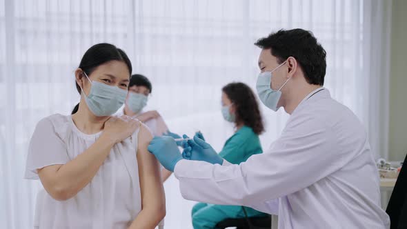 Anxious look of old asian woman vaccinated against COVID-19, health concept.