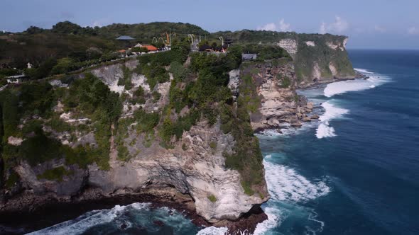 Imposing and craggy limestone cliffs of Bukit Peninsula, Uluwatu, Bali; drone