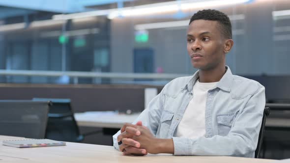 African Man Sitting in Office, Relaxing