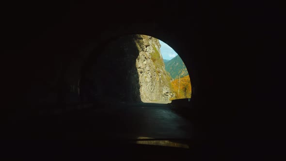 car drives through mountain tunnel. first-person driver drives car