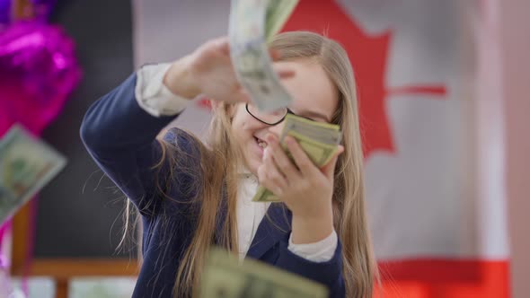 Joyful Teen Schoolgirl Scattering Money in Slow Motion Smiling Looking at Camera with Canadian Flag