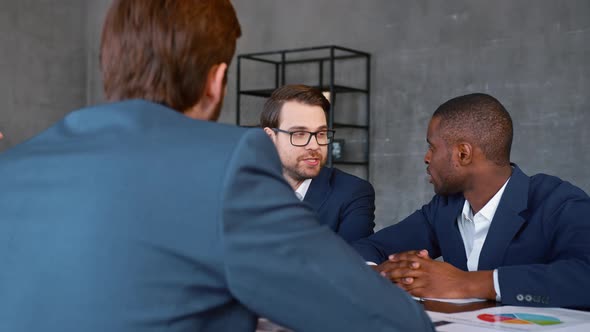 Young multiracial business people enjoying working together at meeting