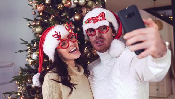 Happy couple celebrating christmas at home.