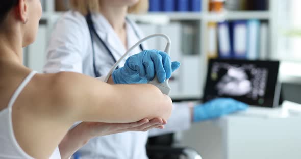 Doctor Conducts Diagnostics of Ultrasound of Bones of Hands of Clinic